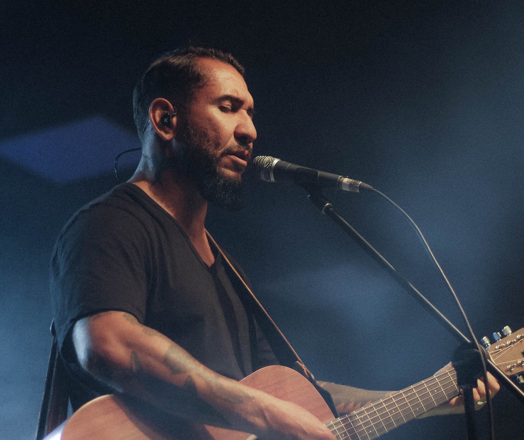 man singing with guitar